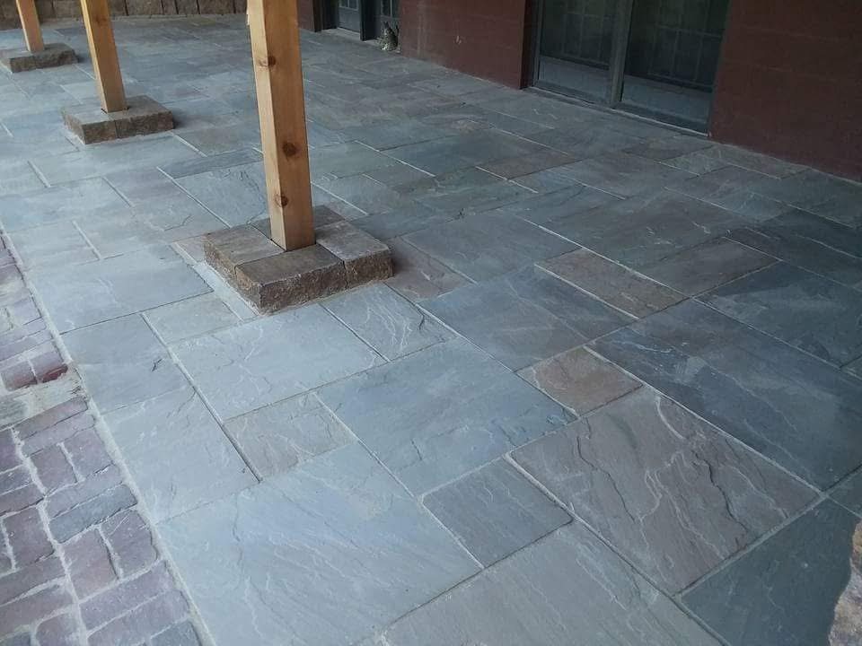 Paver patio installation with stone columns
