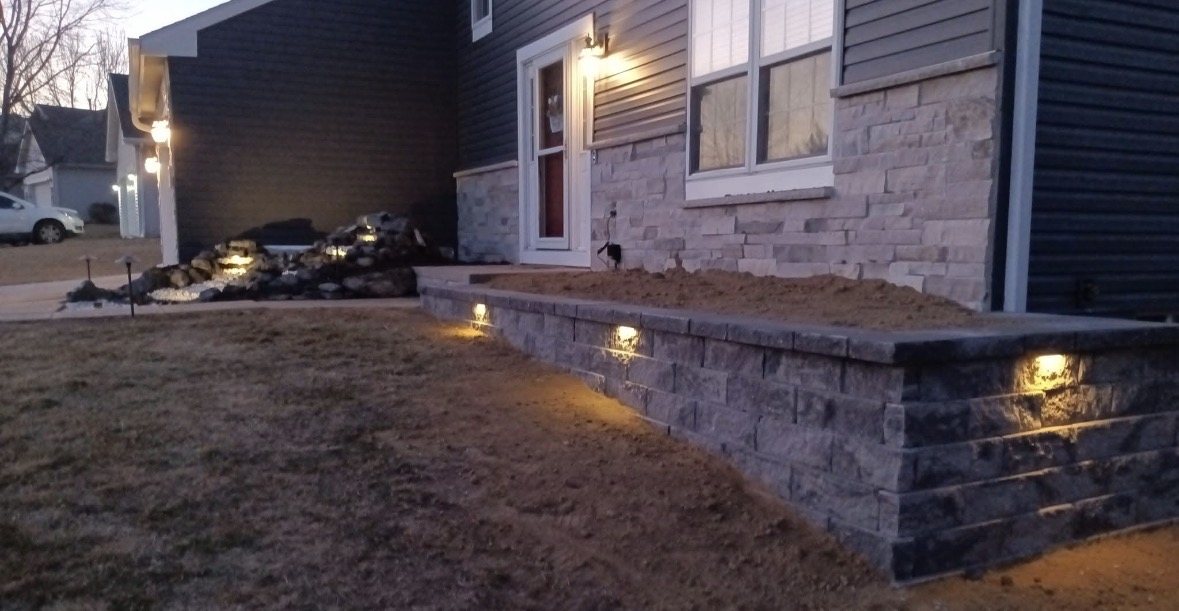 Retaining wall with integrated landscape lighting