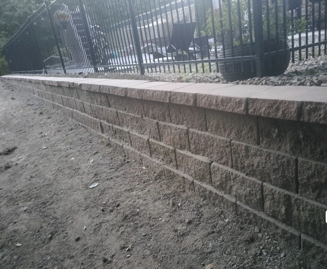 Retaining wall below decorative fence