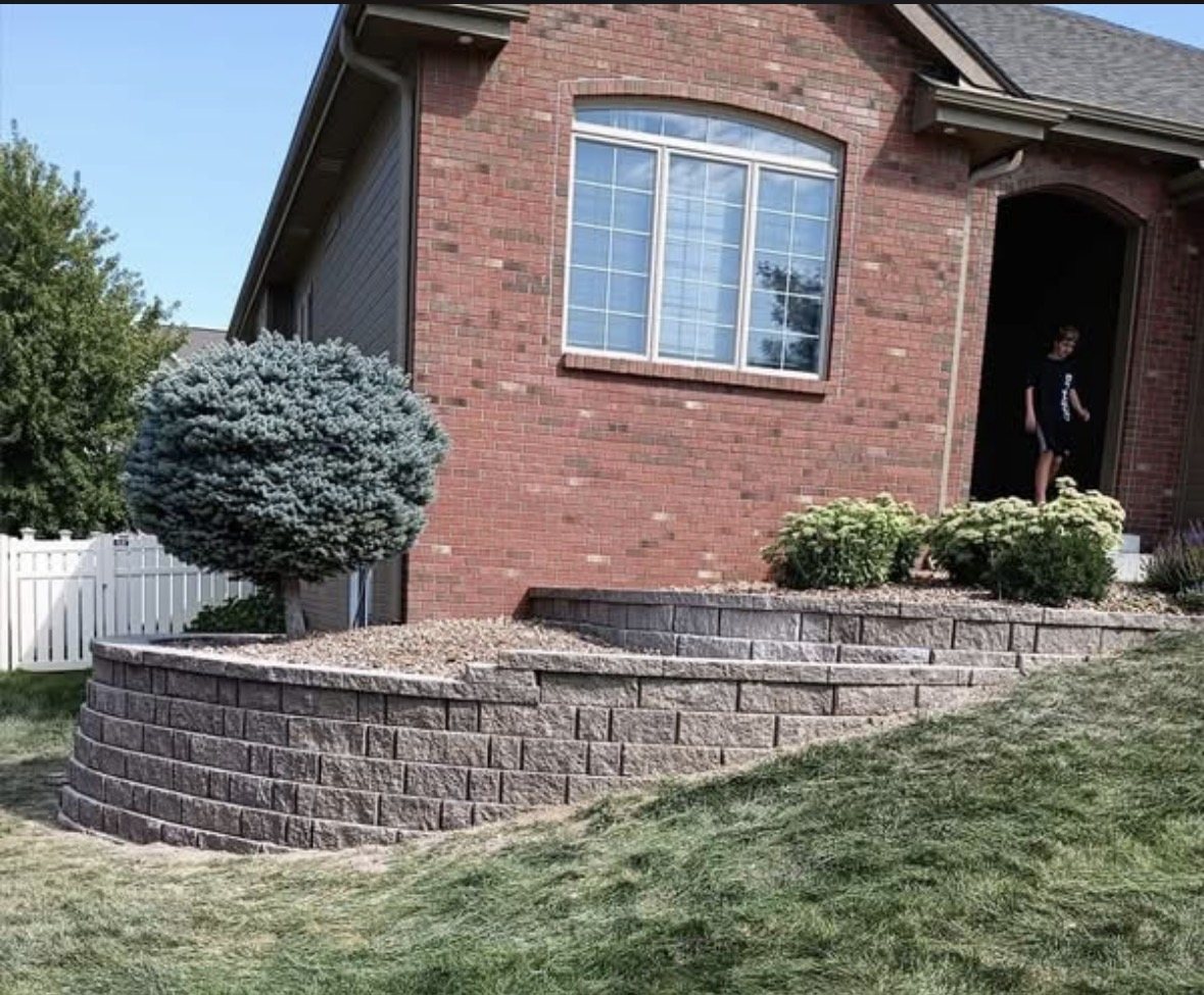 Curved multi-level retaining wall at front landscape
